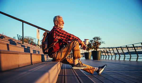 retired man sitting on stairs contemplating strategies for retirement success