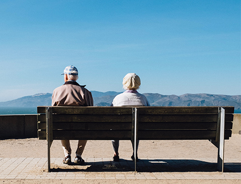 Senior Couple Sitting on Bench Together Looking at the View of Mountains California