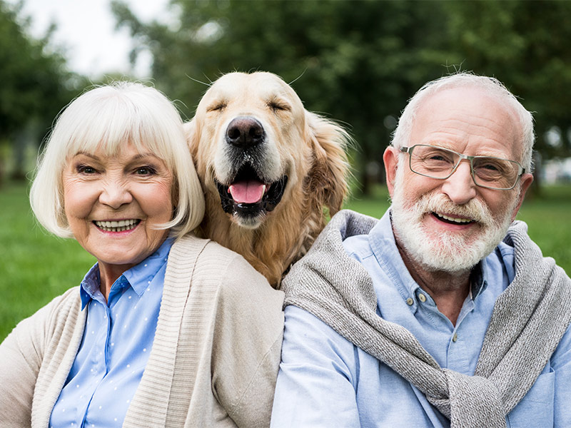 smiling senior couple with their golden retriever lifetime annuity death benefits folsom ca